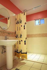 a bathroom with a sink and a shower curtain at Dora's World in Jian