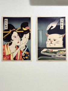 two framed pictures of a woman and a cat at 西九条 CHILL - Nishikujo CHILL in Osaka