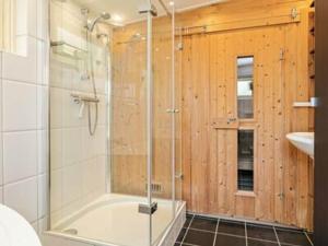 a bathroom with a shower and a tub and a sink at Huijsmans Verhuur Type C Comfort Prinsenhof 68 in Ouddorp +18 photos