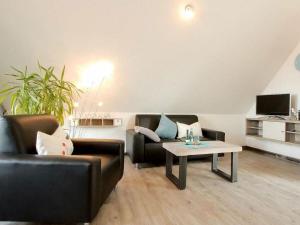 a living room with two couches and a coffee table at Lüerßen directly by the sea apartment 7 in Steinhude