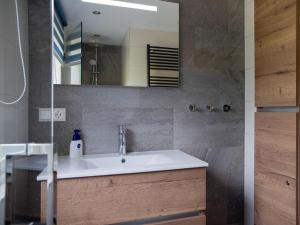 a bathroom with a sink and a mirror at Huijsmans Verhuur Type Deluxe Zuiderdiep 11 in Ouddorp +33 photos