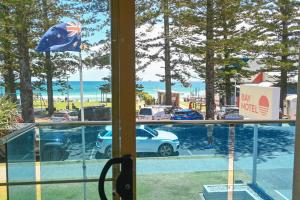 a view from a window of a car dealership at Bay Motel in Byron Bay