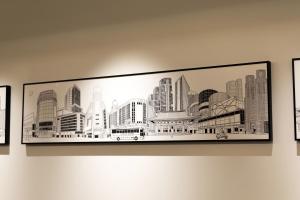a framed picture of a city on a wall at Ginza Capital Hotel Moegi in Tokyo