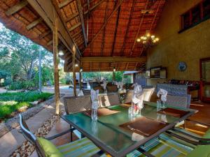 an outdoor dining room with a table and chairs at Kubu Safari Lodge in Hoedspruit