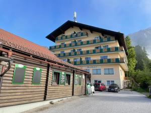 a large building in front of a parking lot at Romantik Apartment mit SommerCard in Ramsau am Dachstein