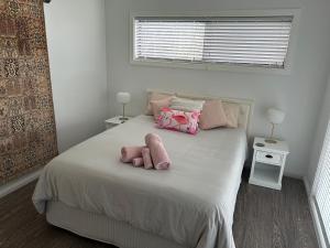 a bedroom with a bed with two stuffed animals on it at Waters Edge Golden Sunrise Two Bedroom Apartment Recent Reno in Rocky Point