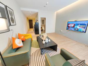 a living room with a couch and a tv at The Tranquil - Bangsar Trade Centre in Kuala Lumpur