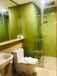 a bathroom with a toilet and a shower and a sink at Sky Suites KLCC by Luna KL in Kuala Lumpur +55 photos