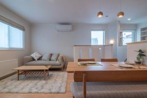 a living room with a couch and a table at 新屋 札幌市中心薄野車程5分 廁所x2 浴室x1 可停車2台 高速Wi-Fi 對街超商 in Sapporo
