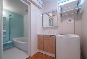 a bathroom with a sink and a toilet and a tub at 新屋 札幌市中心薄野車程5分 廁所x2 浴室x1 可停車2台 高速Wi-Fi 對街超商 in Sapporo