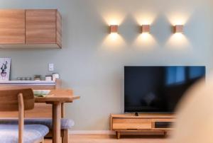 a living room with a large flat screen tv on a wall at 新屋 札幌市中心薄野車程5分 廁所x2 浴室x1 可停車2台 高速Wi-Fi 對街超商 in Sapporo