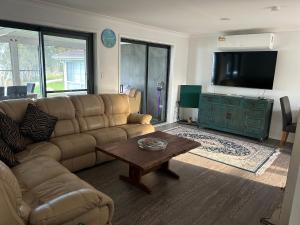 a living room with a couch and a coffee table at Waters Edge Golden Sunrise Two Bedroom Apartment Recent Reno in Rocky Point