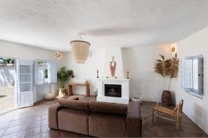 a living room with a couch and a fireplace at Secret Boutique Bracha in Málaga