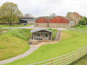 a barn with a gazebo on a grass field at Foxes Den in Darlington