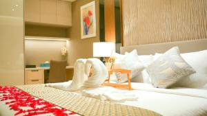 Ein Bett oder Betten in einem Zimmer der Unterkunft Imperial KLCC Residence