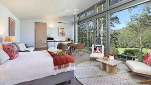 a bedroom with a bed and a large window at Saltwater Creek in Bundannon