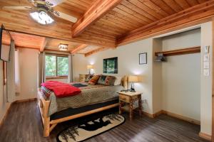 a bedroom with a bed and a wooden ceiling at 3 Springs Hideout- Updated family cabin with hot tub inside Yosemite in Wawona