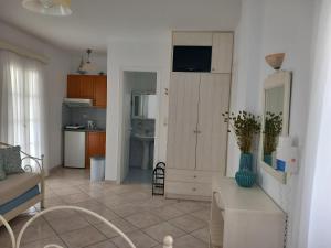 a living room with a couch and a kitchen at Elpidas studios in Agia Anna Naxos +39 photos