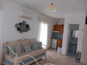 a living room with a couch and a kitchen at Elpidas studios in Agia Anna Naxos