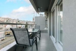 a balcony with a table and a view of a city at FAOS Properties in Kavala