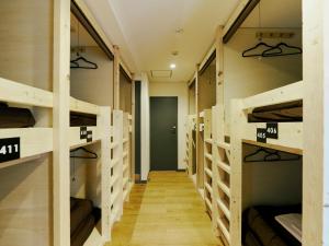 a hallway with multiple bunk beds in a room at Akasaka Guesthouse HIVE in Tokyo