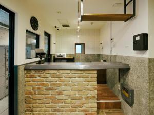 a brick counter in the middle of a room at Akasaka Guesthouse HIVE in Tokyo