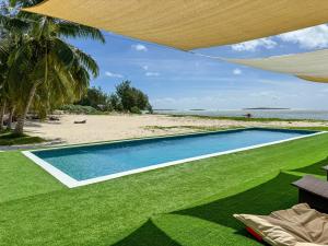 a swimming pool in front of a beach at Royal Sakalava in Diego Suarez