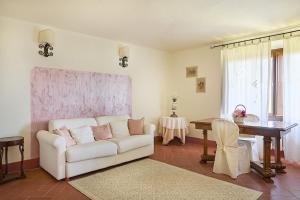 a living room with a white couch and a table at Villa Medicea Lo Sprocco in Scarperia
