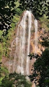 a waterfall on the side of a mountain at Country View Inn in Sungai Lembing