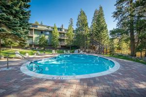 a swimming pool in the middle of a brick patio at Fully Renovated! St Anton #17 Ski in Ski Out 1 Bedroom 1 Bathroom Condo! Sleeps up to 4! in Mammoth Lakes