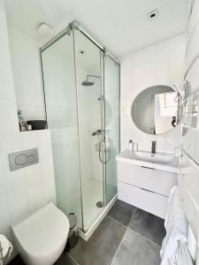 a bathroom with a shower and a toilet and a sink at Escapade marine in Deauville