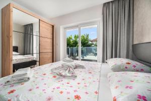 a bedroom with a bed and a large window at Luxury Apartments-LA Dino Maky in Vodice