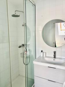 a bathroom with a shower and a sink at Escapade marine in Deauville