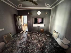 un soggiorno con un orologio sul muro di Haven Retreat a Srinagar