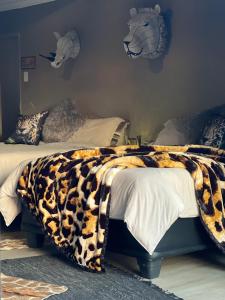 A bed or beds in a room at Simba Safaris African Pride Exotic Lodge