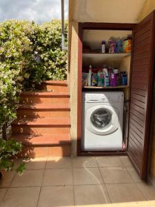 a washing machine sitting inside of a house at Villa a San Teodoro in San Teodoro +11 photos