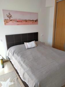 a bedroom with a large bed with a painting on the wall at Guadalest Panorama in Guadalest