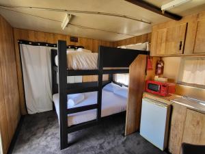 a small room with two bunk beds in a trailer at Kangaroo Lake C & C Park 