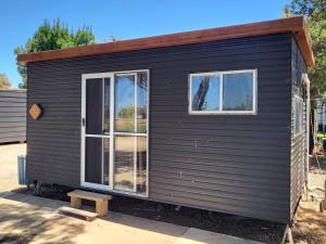 a black tiny house with two windows at Kangaroo Lake C & C Park 