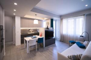 a living room with a couch and a table and a kitchen at Casa Rattazzi by Wonderful Italy in Albisola Superiore