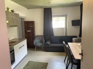 a kitchen and living room with a couch and a table at Flying-Hirsch in Stall