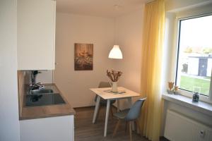 a small kitchen with a table and a window at Apartment Ferientiet in Bergen auf Rügen +18 photos