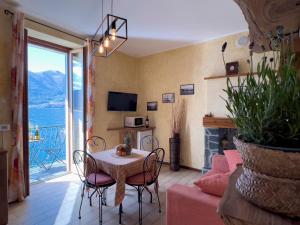 a living room with a table and a couch at Appartamento Try on Lake Como with Balcony in Lezzeno