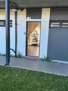 a front door of a house with a porch at Lakhe Lethu Apartment: Green Valley Estate in Nelspruit