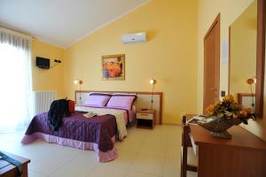 A bed or beds in a room at B&B Casa Augello