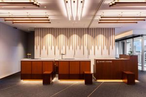 an office lobby with a reception desk and benches at Tokyu Stay Osaka Hommachi in Osaka