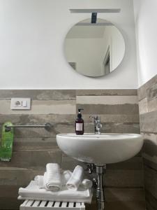 a bathroom with a sink and a mirror at Essentia Rooms & Relax in Vasto