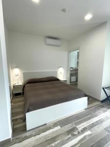 a bedroom with a bed in a white room at Essentia Rooms & Relax in Vasto