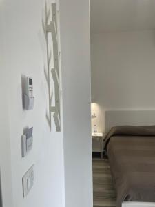a bedroom with a bed and a wall with switches at Essentia Rooms & Relax in Vasto