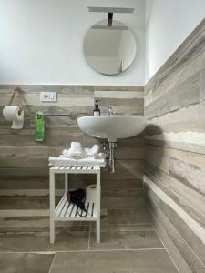 a bathroom with a sink and a mirror at Essentia Rooms & Relax in Vasto